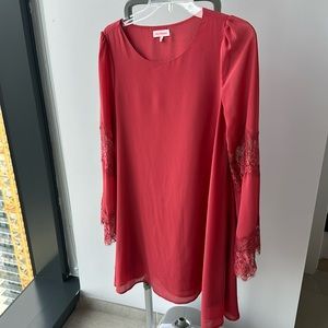 Coral dress with lace sleeve detail. In excellent condition.